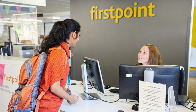 Student speaking with a staff member at the firstpoint helpdesk